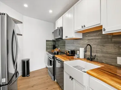 a kitchen with white cabinets and a stainless steel refrigerator at Experience the Beauty of Tahoe from Your Zephyr Cove Retreat! #2 in Zephyr Cove