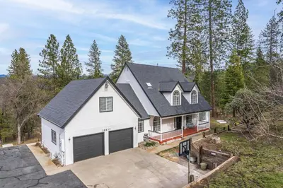 an aerial view of a white house with a garage at Luxury Family Villa Sleeps 20 in Coarsegold
