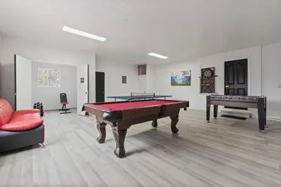 a living room with a pool table and a couch at Luxury Family Villa Sleeps 20 in Coarsegold