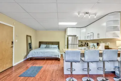a bedroom with a bed and a kitchen with a counter at First level studio suite close to everything bike, ski, swim Zephyr Cove! in Zephyr Cove