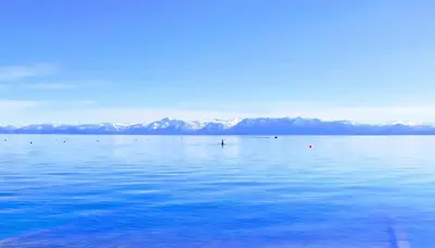 a large body of water with mountains in the background at First level studio suite close to everything bike, ski, swim Zephyr Cove! in Zephyr Cove