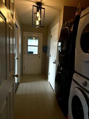 a hallway of a home with a washer and dryer at Yosemite Vista Highlands in Oakhurst
