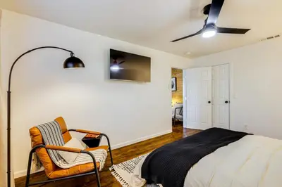 a bedroom with a bed and a chair at Access to Pine Mountain Lake Family Cabin with Deck in Groveland
