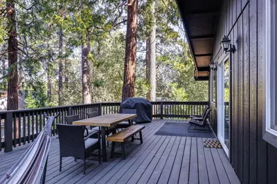 a wooden deck with a wooden table and chairs at Access to Pine Mountain Lake Family Cabin with Deck in Groveland