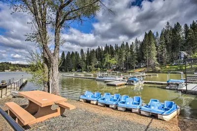 a group of blue chairs sitting in the water at Access to Pine Mountain Lake Family Cabin with Deck in Groveland