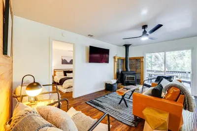 a living room with a couch and a fireplace at Access to Pine Mountain Lake Family Cabin with Deck in Groveland