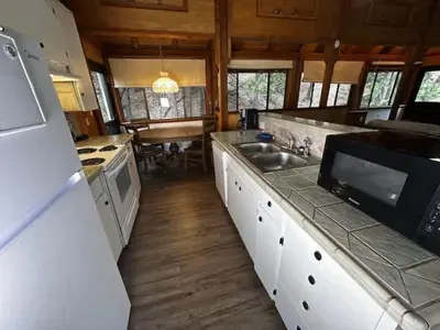 a kitchen with a sink and a stove top oven at Views inside Yosemite-Timber Lodge-Sleeps 6 in Yosemite West
