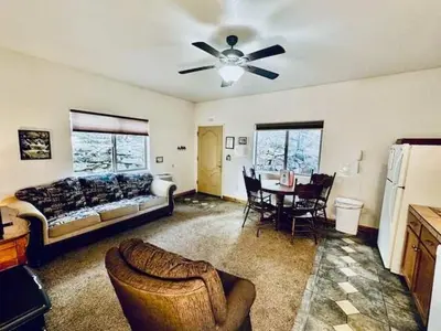 a living room with a bed and a table with chairs at Lower Unit-Yosemite Woods-Inside Yosemite in Yosemite West