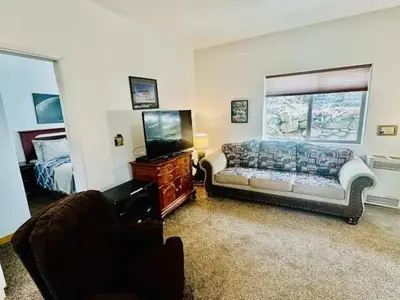 a living room with a couch and a television at Lower Unit-Yosemite Woods-Inside Yosemite in Yosemite West