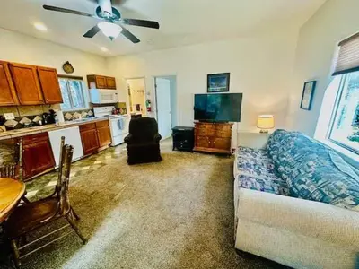 a living room with a couch and a kitchen at Lower Unit-Yosemite Woods-Inside Yosemite in Yosemite West