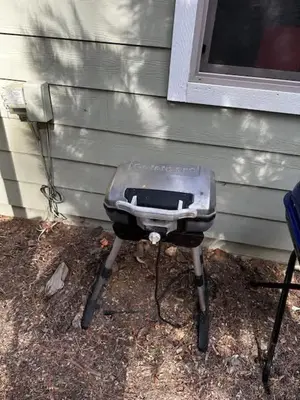 a charcoal grill sitting outside of a house at Lower Unit-Yosemite Woods-Inside Yosemite in Yosemite West