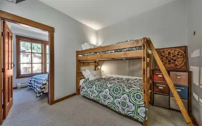a bedroom with a bunk bed and a bedroom with a ladder at Palisades Village ski in ski out Mountain Retreat in Olympic Valley