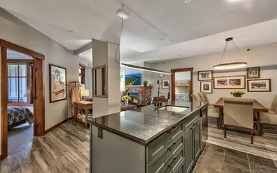 a kitchen with a counter top and a dining room at Palisades Village ski in ski out Mountain Retreat in Olympic Valley