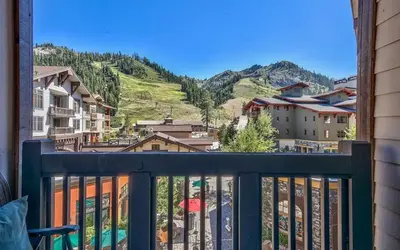 a balcony with a view of a mountain at Palisades Village ski in ski out Mountain Retreat in Olympic Valley