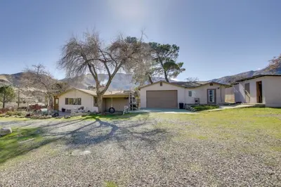 a house with a garage in the middle of a yard at Lake and Mountain Views Cozy California Stay in Mountain Mesa