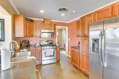 a kitchen with wooden cabinets and a stainless steel refrigerator at 6 Mi to Lake Isabella Mountain Mesa Getaway in Mountain Mesa