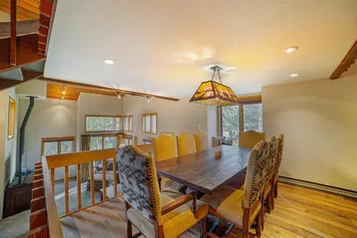 a dining room with a wooden table and chairs at Plush Mammoth Condo w Balcony Views in Mammoth Lakes