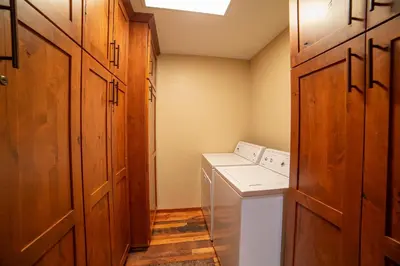 a laundry room with a washer and dryer in it at Plush Mammoth Condo w Balcony Views in Mammoth Lakes