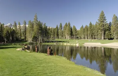 a group of people standing next to a body of water at Plush Mammoth Condo w Balcony Views in Mammoth Lakes