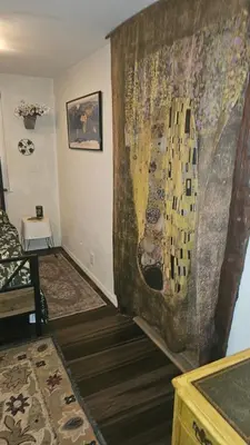 a living room with a large painting on the wall at The Secret Hideaway in Oakhurst