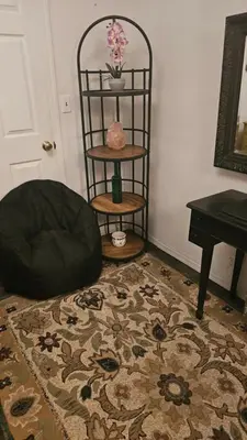a living room with a chair and a table and a rug at The Secret Hideaway in Oakhurst