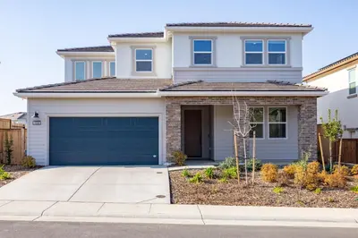 a white house with a garage at Modern Charming 4BR Home, Family Friendly, Office Space, Fast WiFi, Free Parking in Folsom