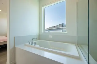 a white bathroom with a sink and a window at Modern Charming 4BR Home, Family Friendly, Office Space, Fast WiFi, Free Parking in Folsom