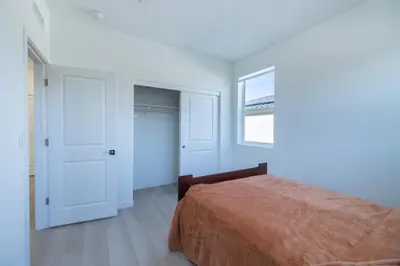 a white bedroom with a bed and a window at Modern Charming 4BR Home, Family Friendly, Office Space, Fast WiFi, Free Parking in Folsom