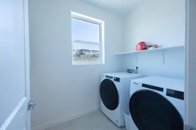 a white washing machine in a white laundry room at Modern Charming 4BR Home, Family Friendly, Office Space, Fast WiFi, Free Parking in Folsom