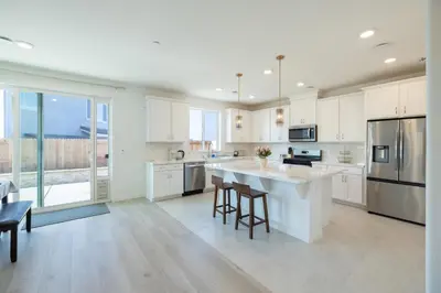 a kitchen with white cabinets and a large island at Modern Charming 4BR Home, Family Friendly, Office Space, Fast WiFi, Free Parking in Folsom