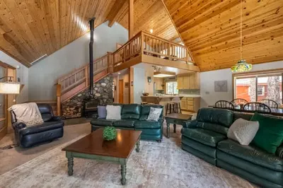 a living room with green furniture and a wooden ceiling at Evergreen Escape in Truckee
