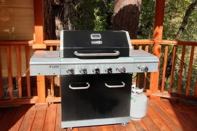 a grill sitting on top of a deck at Black Oak Lodge at The Redwoods in Wawona
