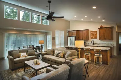 a living room with couches and a kitchen at Spring Meadow Retreat in Wawona
