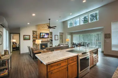 a kitchen and living room with a couch and a table at Spring Meadow Retreat in Wawona