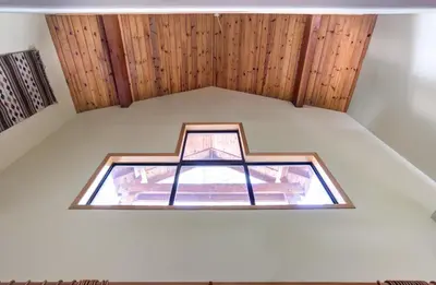 a window in the ceiling of a room with wooden walls at Cabin Twelve in Wawona