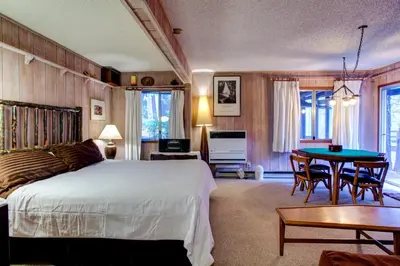 a bedroom with a bed and a table in it at Star Gazers in Wawona