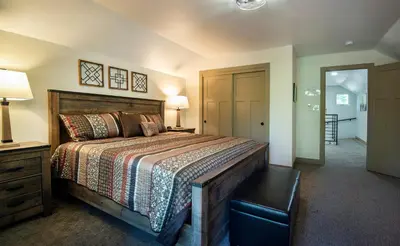 a bedroom with a large bed with a wooden headboard at Hilltop Haven in Wawona