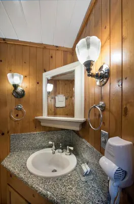 a bathroom with a sink and a mirror at Chipmunk Hollow in Wawona