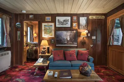 a living room with a blue couch and a table at Chipmunk Hollow in Wawona