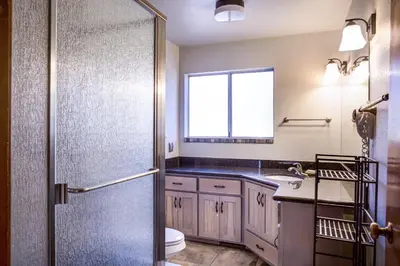 a bathroom with a shower and a toilet and a sink at The Legacy in Wawona