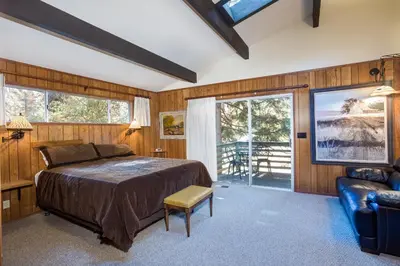 a bedroom with a bed and a couch and windows at The Legacy in Wawona