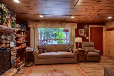 a living room with a couch and a chair at Chipmunks Holiday in Wawona