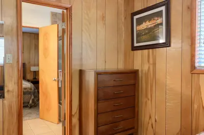 a bedroom with a dresser and a picture on the wall at New Beginnings at The Redwoods Cabin in Wawona