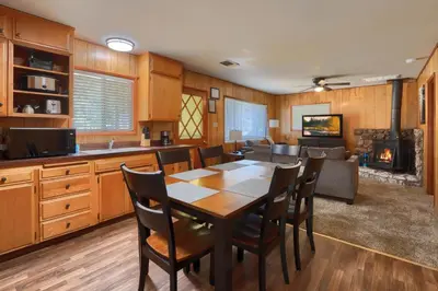 a kitchen and dining room with a table and chairs at New Beginnings at The Redwoods Cabin in Wawona