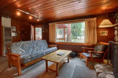 a living room with a couch and a table at Le Fawn in Wawona