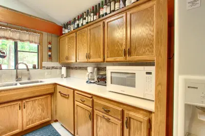 a kitchen with wooden cabinets and white appliances at Pohono Pines in Wawona
