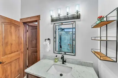 a bathroom with a sink and a mirror at Big Foots Den on the 10 Northstar Resort Truckee in Truckee
