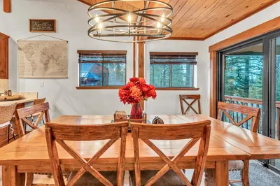a dining room with a wooden table and chairs at Big Foots Den on the 10 Northstar Resort Truckee in Truckee