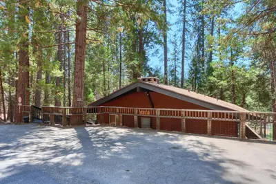 a brown house in the middle of a forest at Hiltbrand Hangout in Wawona