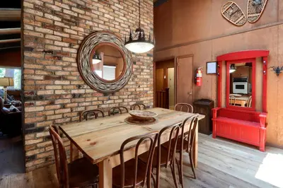 a dining room with a wooden table and chairs at Hiltbrand Hangout in Wawona